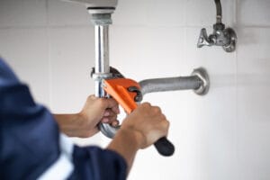plumber performing a leak repair